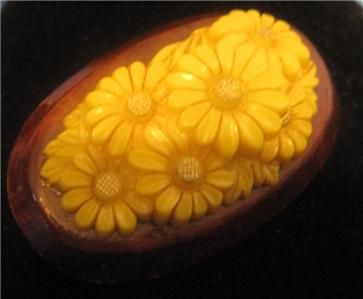 For sale is a lovely, deeply carved, daisies in plastic on wood brooch 